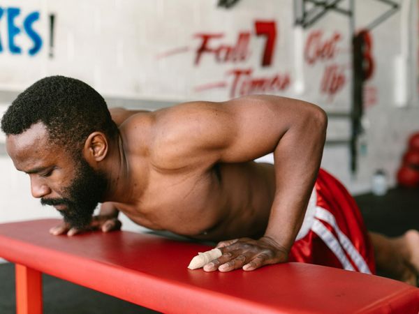 Man focused during a challenging bodyweight exercise.