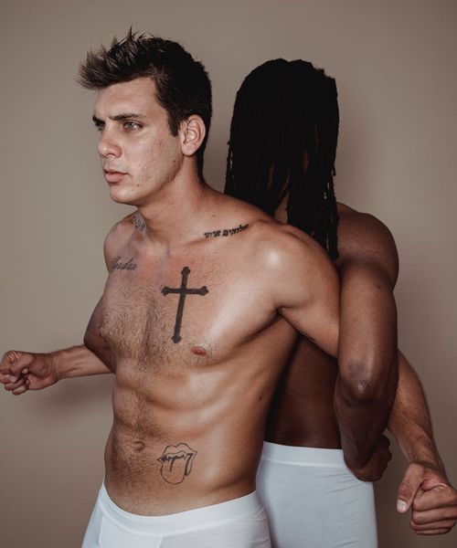 Man performing a controlled strength exercise in a modern gym.